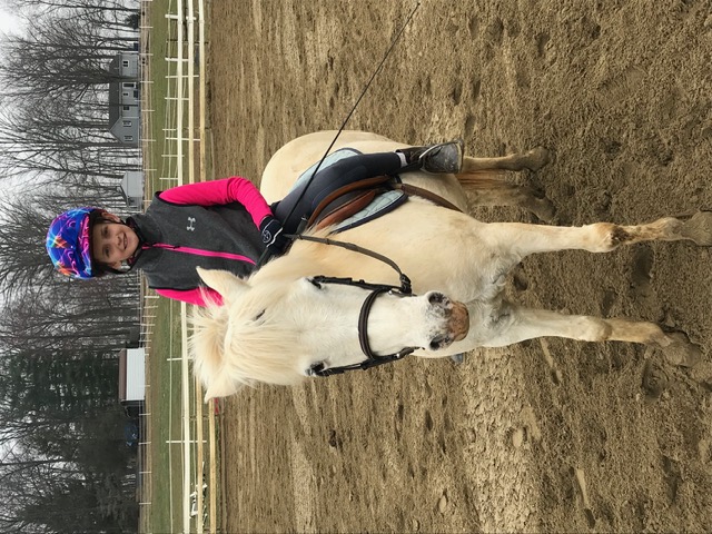 Young Rylen on a pony in the arena