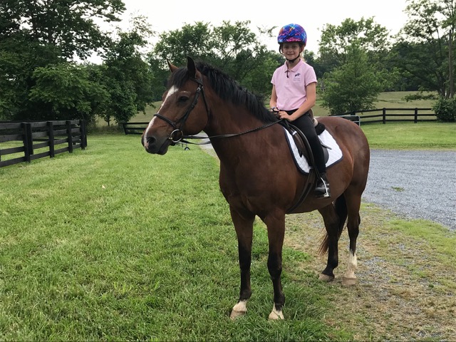 Young Rylen riding a bay horse
