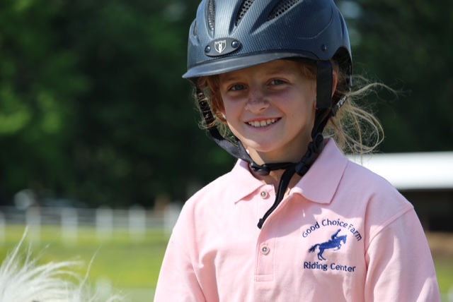 Young Rylen smiling in a riding helmet